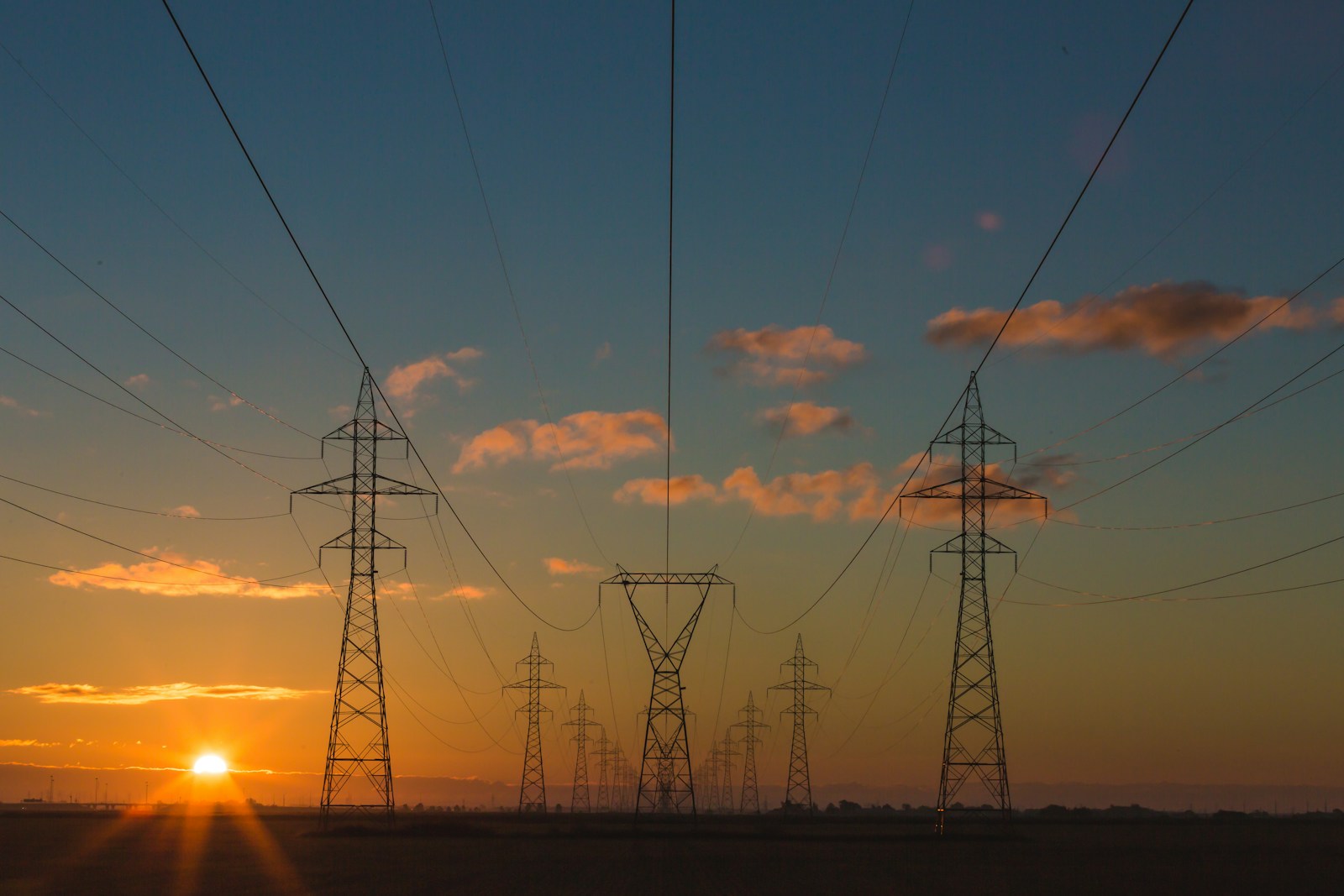 High voltage power transmission lines over green Nordic landscape